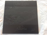 laser engraved picture of lake Louise background  on a black ceramic tile.