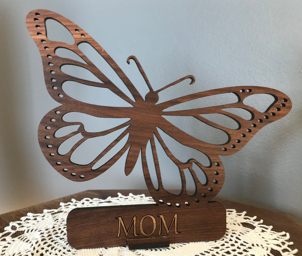 laser cut butterfly ornament  from wood with small personalized name plaque, capable of standing on a shelve or table.