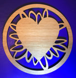 round wooden coaster with artistic ovals holding a heart shape in the centre.